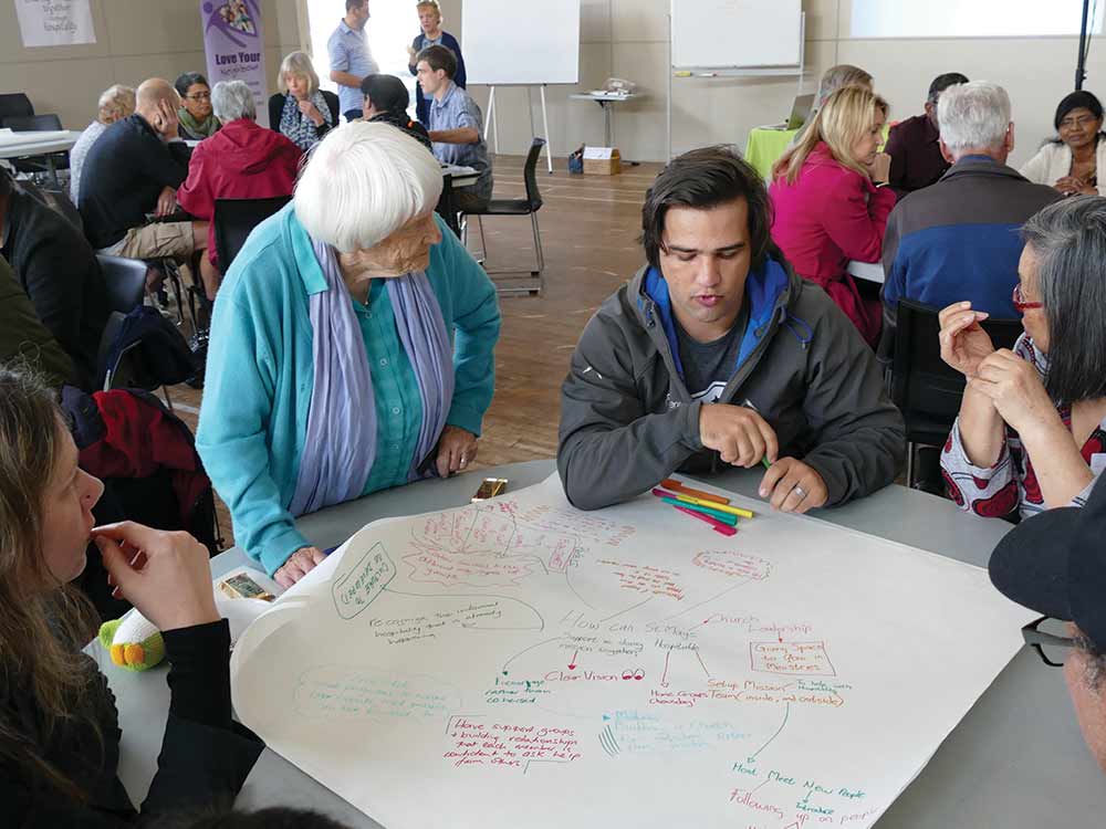 Older lady involved with table discussion