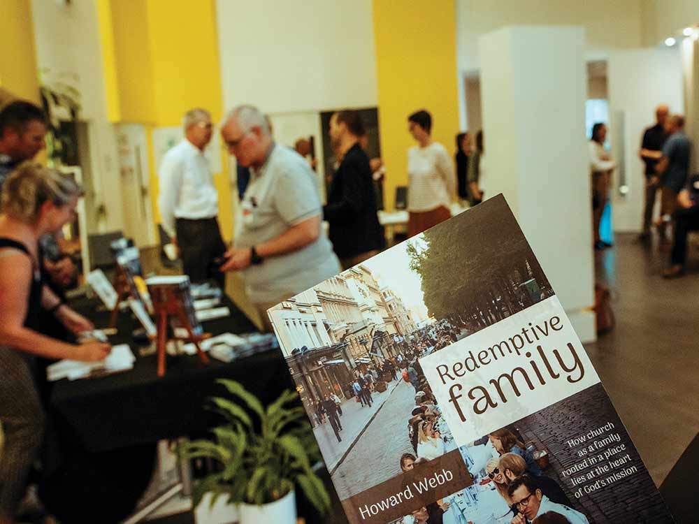 REDEMPTIVE FAM BOOK in front of blurred book table Steve laugh MT Albert